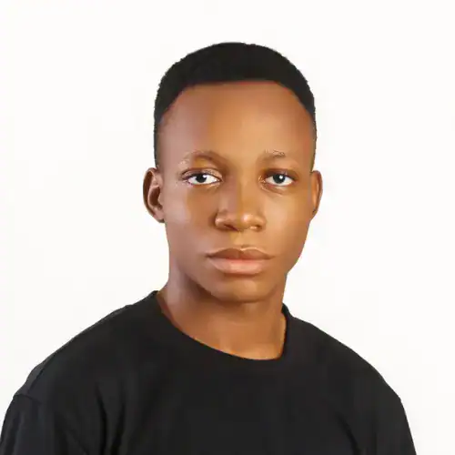 Portrait of a confident young man with short black hair and a black shirt, representing professional.